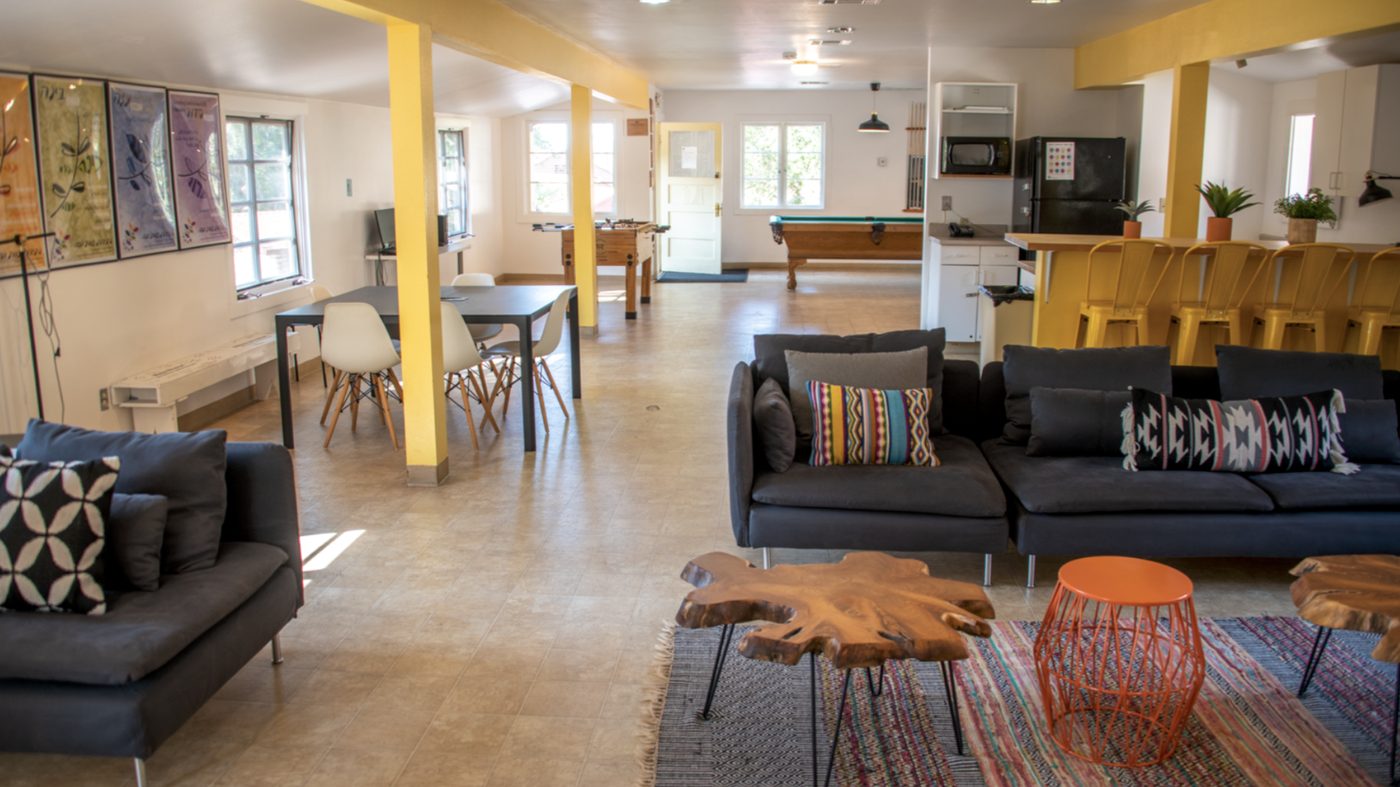 Inside the staff lounge — couches, dining table, foosball, and pool table