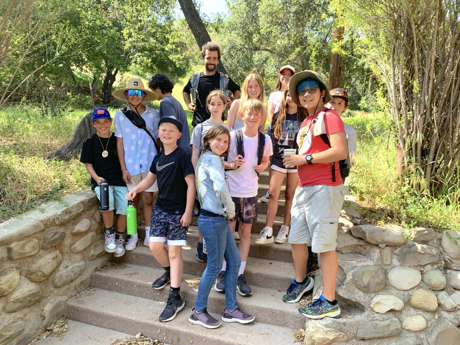 A Naturalist with a group of 6th grade students on the trail steps at Camp Ramah
