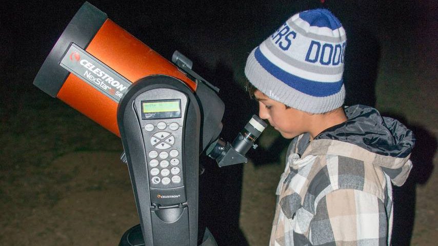 A student at the telescope on the night hike